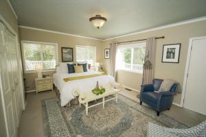 a bedroom with a bed and a blue chair at Warm Springs Inn & Winery in Wenatchee
