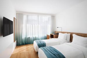 Postel nebo postele na pokoji v ubytování Hotel Arpoador