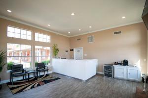 an office with two chairs and a counter in a room at Countryside Inn in Kaufman