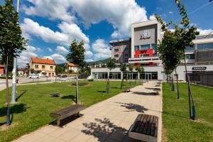 a park with a building with a clock on it at Hotel IUT in Travnik
