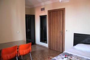 a bedroom with orange chairs and a bed and a door at Le Moral Apart Hotel in Alanya