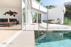 a modern house with a swimming pool and a living room at Vista Roses Mar - Cap Ponent in Roses