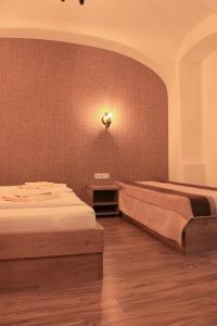 a bedroom with a bed and a wall at Corso Comfort Apartments in Sibiu