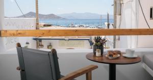 a table with a bowl of food on a boat at Kissos Luxury Suites in Naxos Chora