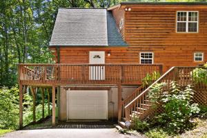 a wooden house with a garage in front of it at Hawks Landing in Sylva