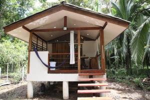 a small house with a staircase leading up to it at Green Corner in Cahuita