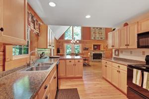 a large kitchen with wooden cabinets and a sink at Hawks Landing in Sylva