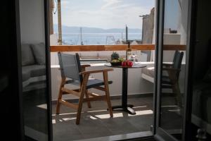 a table and chairs on a balcony with a view of the ocean at Kissos Luxury Suites in Naxos Chora +67 photos