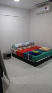 a bed in a room with a colorful mattress at Spacious & Cozy Condo - Hijauan Heights Block C in Kajang +9 photos