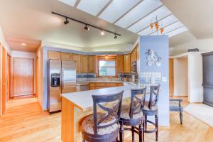 a kitchen with a large island with bar stools at Lake Life at Wapato Point in Manson