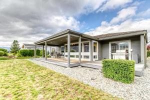 a house with a porch and a lawn at Lake Life at Wapato Point in Manson