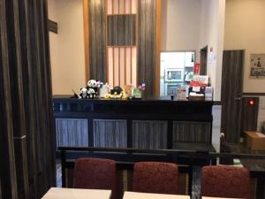 a room with a table and chairs and a counter at Ueno Urban Hotel in Tokyo