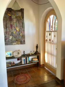 an archway in a room with a book shelf and a door at Residência Acolhedora in Porto Alegre