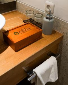 a wooden counter with a soap dispenser in a bathroom at Villa Aquin in Solo
