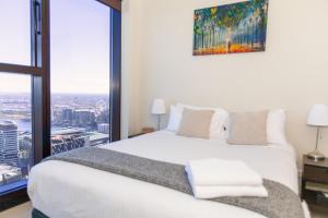 a hotel room with a bed and a window at Melbourne SkyHigh Apartments in Melbourne