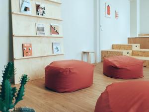 a room with two red bean bags on the floor at Hostel Tomato 番茄溫泉青旅 in Jiaoxi