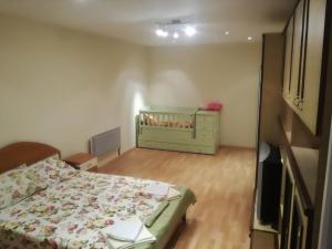 a small bedroom with a bed and a dresser at Comfortable 2-bedroom apartment in Burgas