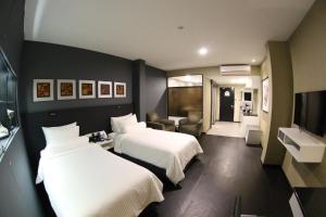 Postel nebo postele na pokoji v ubytování Bedrock Hotel Ipoh