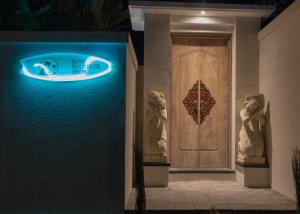 a building with two statues in front of a door at Aloha Beach House Bingin in Uluwatu