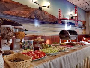 a buffet with plates of food on a table at Hotel Granada in Ostrów Wielkopolski