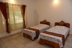 Zimmer mit 2 Betten und einem Fenster in der Unterkunft Vamoose Hideaway in Chikmagalur