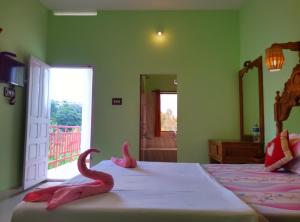 A bed or beds in a room at Panthalams Homestay