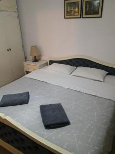 a bedroom with a large bed with a blue pillow on it at Bochkar Guest House in Ohrid