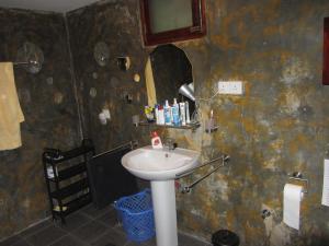 a bathroom with a sink and a mirror at Mallis Guesthouse in Habaraduwa Central