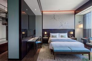 Postel nebo postele na pokoji v ubytování NUO Hotel Beijing
