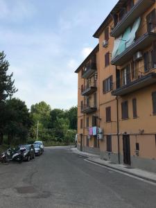 a building with cars parked on the side of a street at Tra S.Orsola e Fiera in Bologna +12 photos