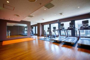 a gym with cardio equipment in a large room with windows at Keio Plaza Hotel Tokyo in Tokyo