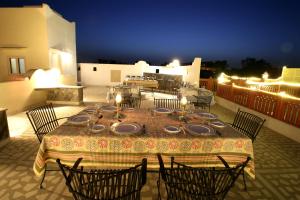 a table and chairs on a patio at night at Khatu Haveli in Jaipur