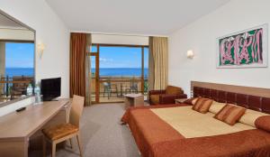A television and/or entertainment centre at Sol Nessebar Palace All Inclusive