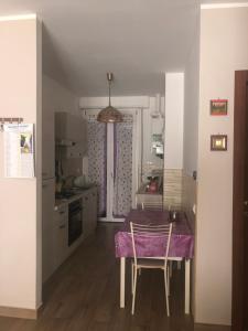 a kitchen with a table and chairs in a room at GIUSY’ S HOUSE in Sulmona