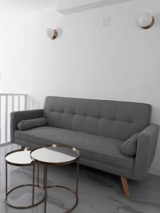 a living room with a couch and two tables at La Mar de Ben in Muros