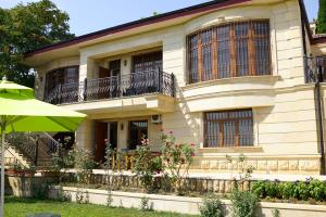 a large house with balconies and a table at Seaview Villa Buzovna Sameya in Buzovna