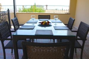 a dining room table with a bowl of fruit and wine glasses at Seaview Villa Buzovna Sameya in Buzovna