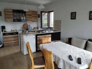 a kitchen and dining room with a table and chairs at Bobekova Kashta in Panagyurishte