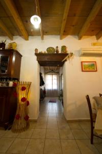a living room with a ceiling with wooden beams at Locanda La Rosa in Pauli Arbarei +44 photos