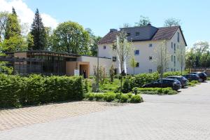 a building with cars parked in a parking lot at Ammerseehäuser in Dießen am Ammersee