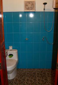 a blue tiled bathroom with a toilet and a shower at Tea Moon Boutique Stay in Thong Sala +58 photos