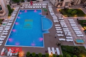 an overhead view of a large swimming pool with white tables and chairs at TSB Sunny Victory in Sunny Beach