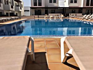 a large swimming pool with chairs in a hotel at Casa Zen in Puerto Calero