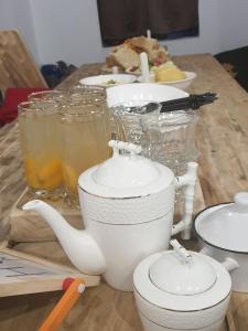 a table with a tea kettle and glasses of juice at Panorama guesthouse Mata C. in Adishi