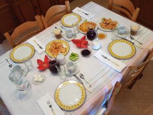 a table with plates of food on it at Hotel Villa Ago in Përmet