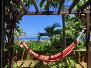 a hammock with a view of the ocean at Somos in Nakijin