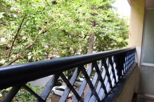 a balcony with a black railing and trees at YWCA International Centre in Mumbai