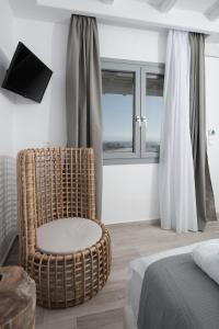 Ένα ή περισσότερα κρεβάτια σε δωμάτιο στο Iliada Suites