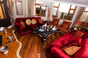 a living room with red couches and a table at THE SIGN Şile Hotel & Spa in Istanbul