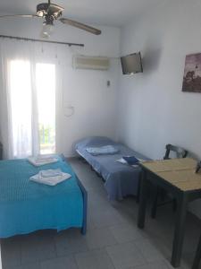 A bed or beds in a room at Studios Panorama Drios